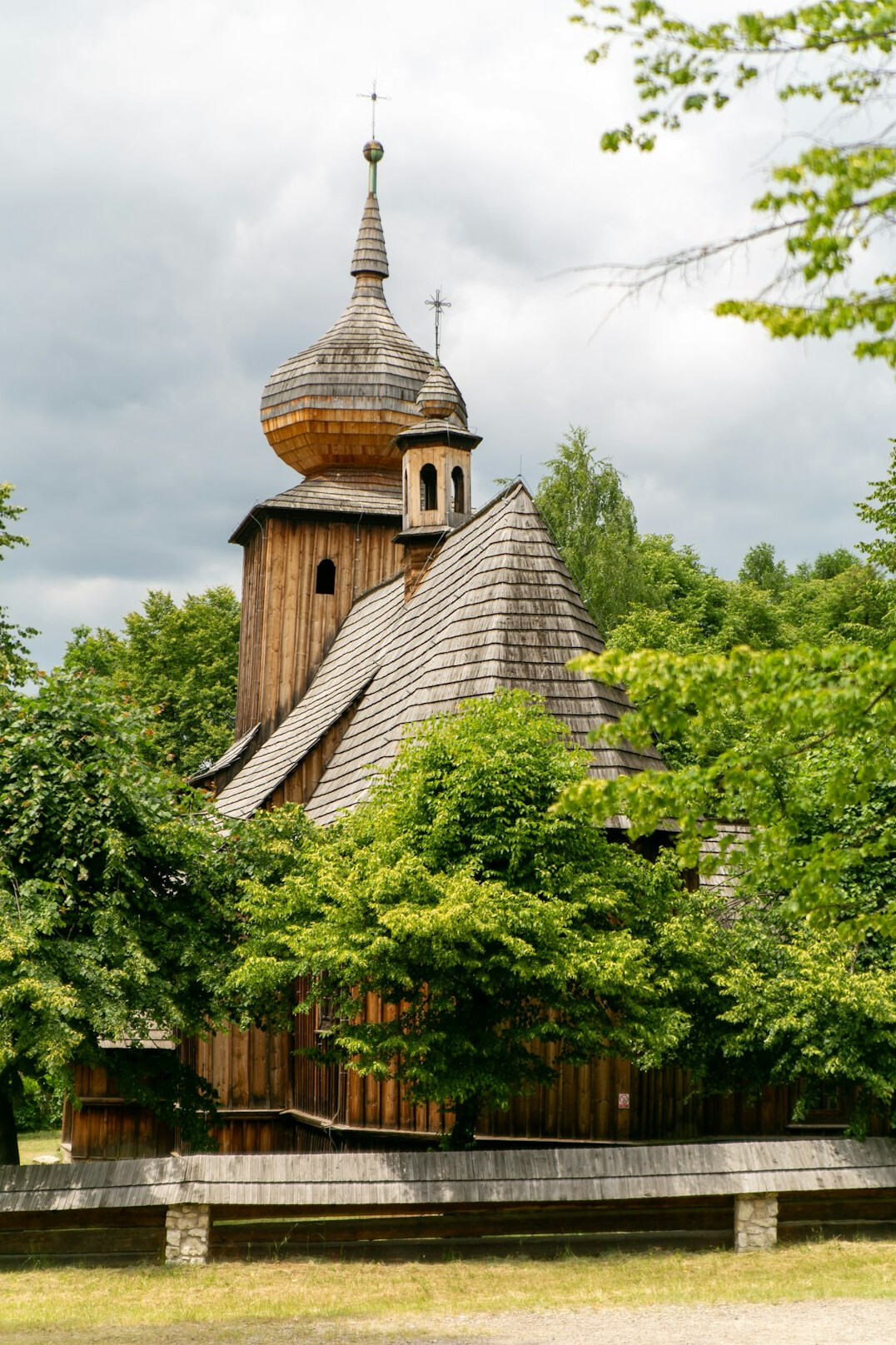 Wooden Polish village church surrounded by trees