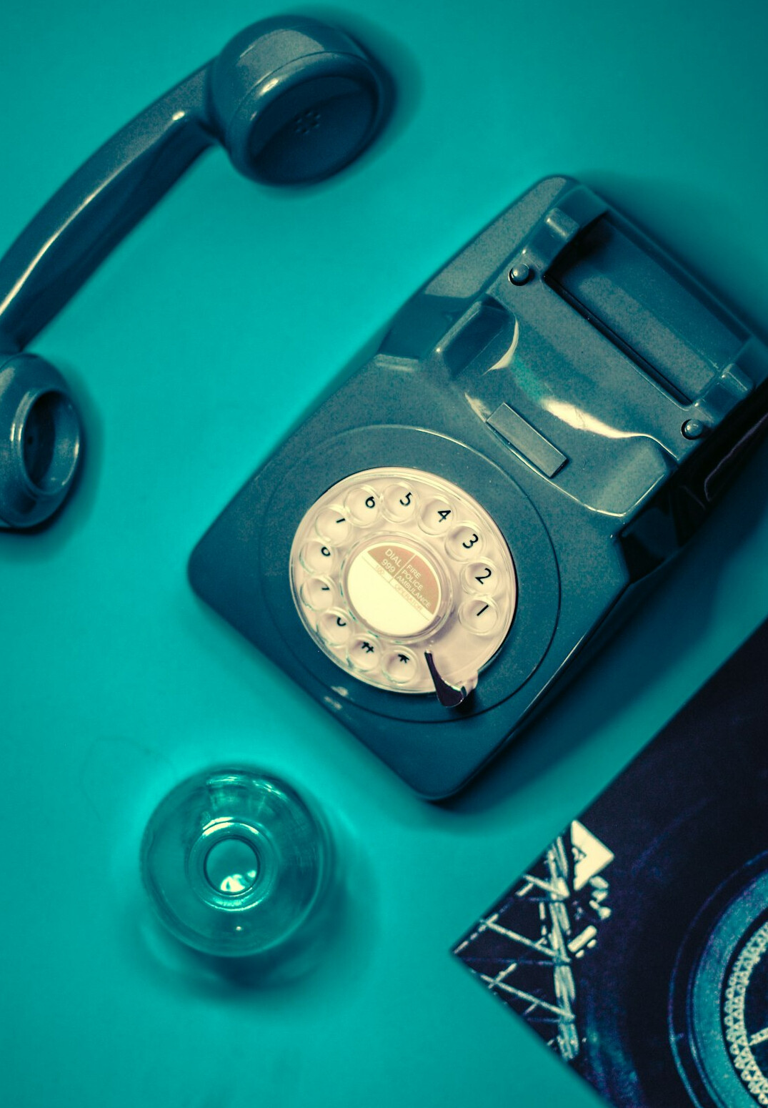 Old rotary telephone and letters on a wooden desk